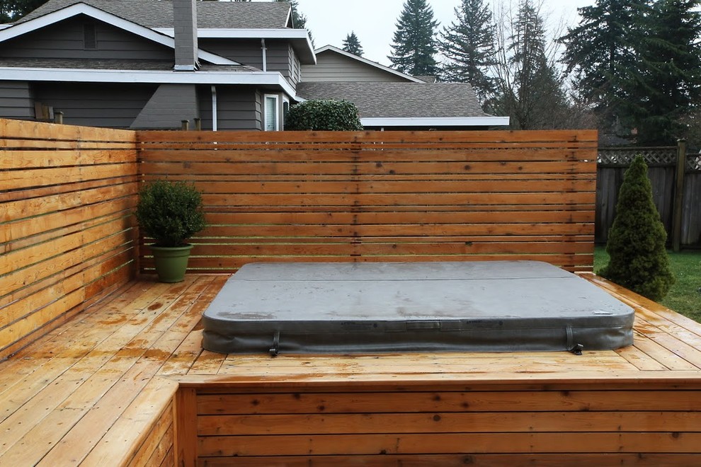 Example of a large mountain style backyard water fountain deck design in Vancouver with no cover