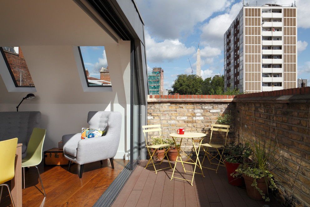 Large contemporary rooftop deck in London with with privacy feature and no cover.