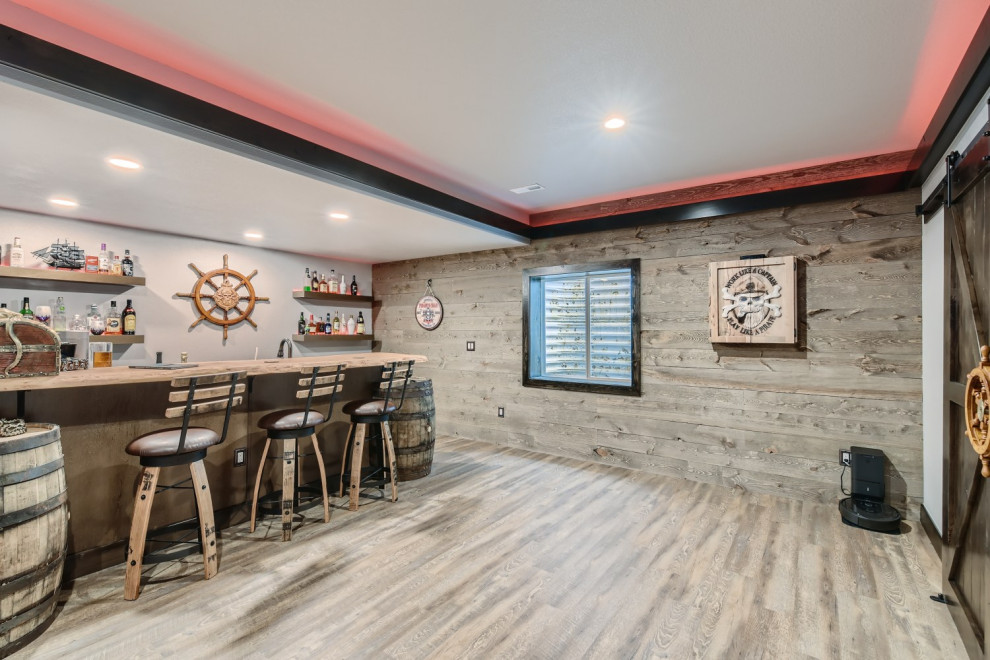 Inspiration for a large eclectic vinyl floor and gray floor basement remodel in Denver with a bar and gray walls