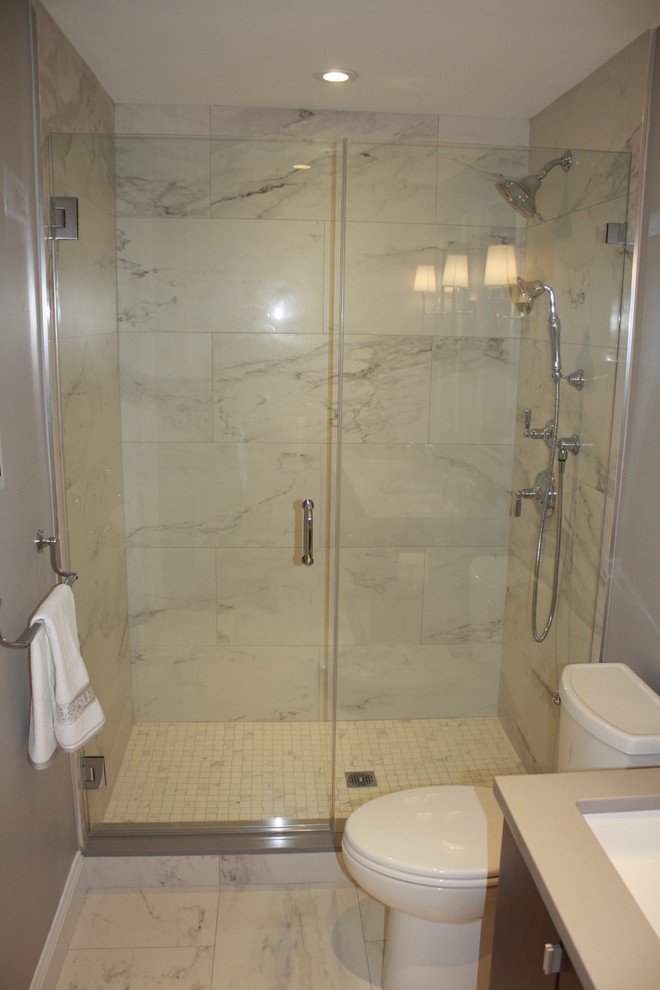 Small modern master bathroom in Boston with flat-panel cabinets, brown cabinets, gray tile, white tile, marble, grey walls, marble floors, an undermount sink, solid surface benchtops, grey floor, an alcove shower and a hinged shower door.