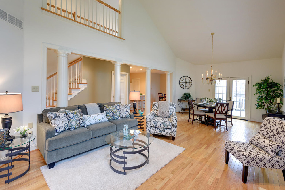 Mid-sized traditional open concept living room in Philadelphia with light hardwood floors.
