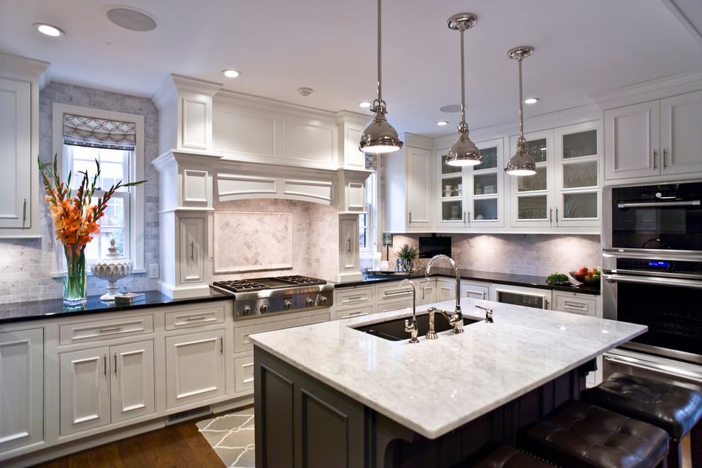 Inspiration for a mid-sized transitional u-shaped medium tone wood floor and brown floor eat-in kitchen remodel with an undermount sink, beaded inset cabinets, white cabinets, quartz countertops, multicolored backsplash, subway tile backsplash, stainless steel appliances and an island