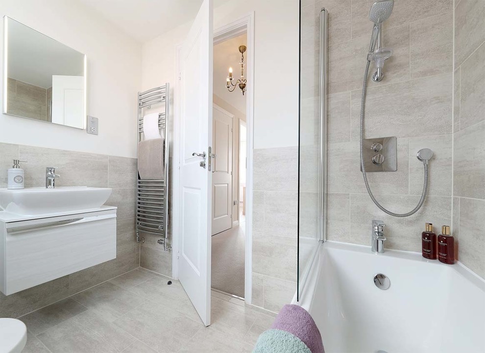Design ideas for a large modern master bathroom in Essex with raised-panel cabinets, white cabinets, an alcove tub, an alcove shower, a two-piece toilet, gray tile, white walls, a drop-in sink, grey floor, a hinged shower door and white benchtops.