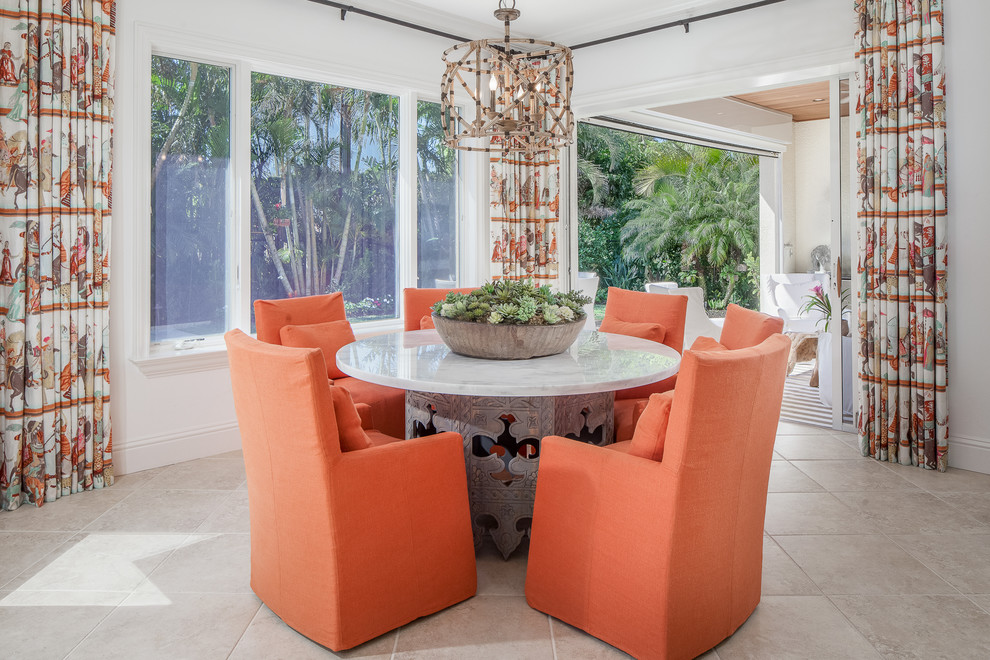 Design ideas for a tropical separate dining room in Miami with white walls and grey floor.