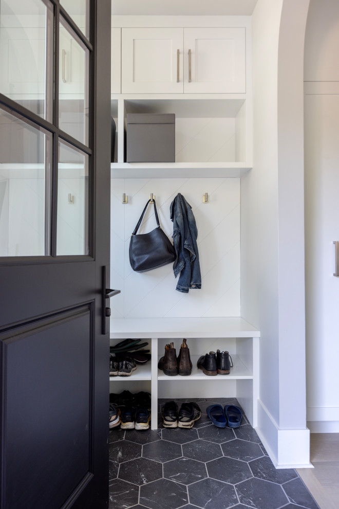 Photo of a mid-sized transitional mudroom in Vancouver with grey walls, porcelain floors, a single front door, a black front door, black floor and panelled walls.