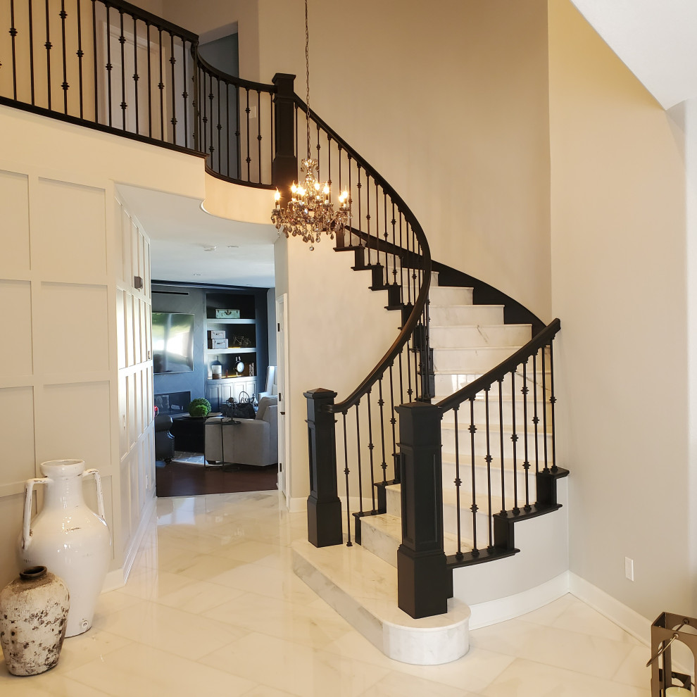 Design ideas for a large transitional marble curved staircase in San Diego with marble risers and mixed railing.