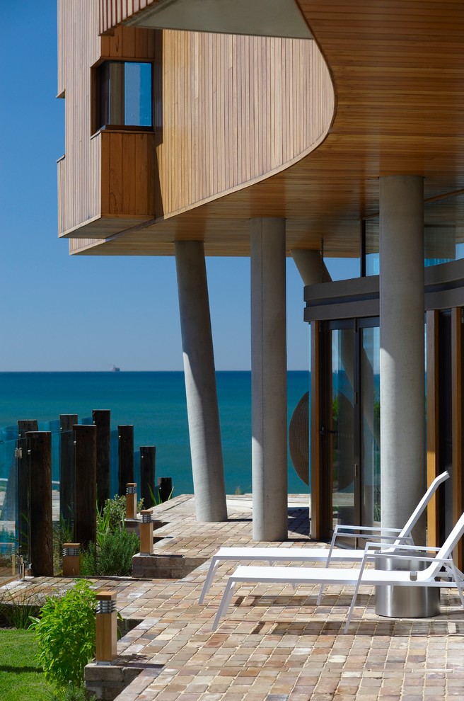 This is an example of a beach style patio in Wollongong.