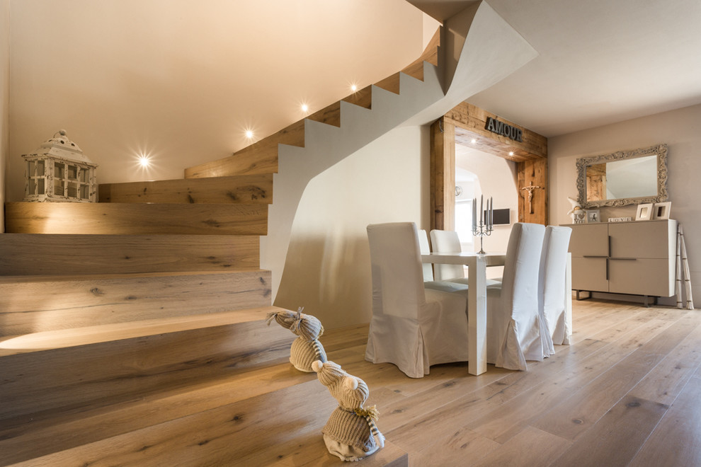 Inspiration for a mid-sized country wood curved staircase in Other with wood risers.