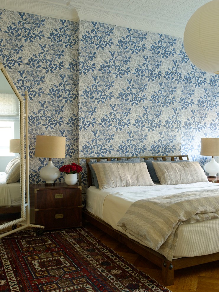 Photo of a transitional master bedroom in New York with blue walls.