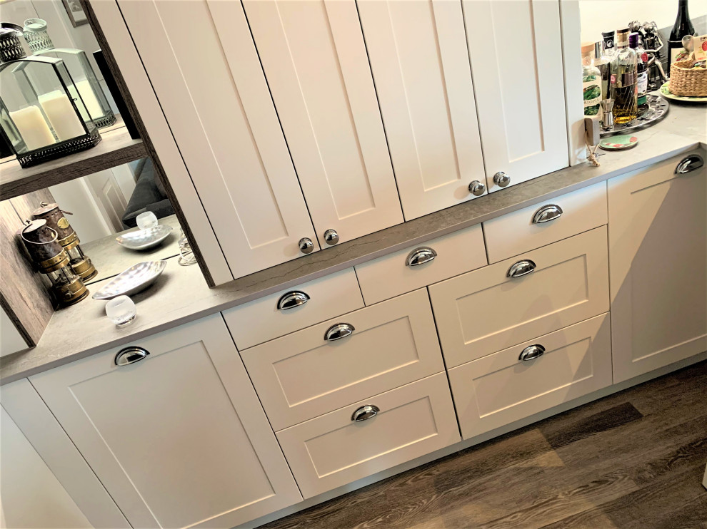 Inspiration for a small timeless single-wall vinyl floor and gray floor eat-in kitchen remodel in Other with a farmhouse sink, shaker cabinets, medium tone wood cabinets, quartz countertops and gray countertops