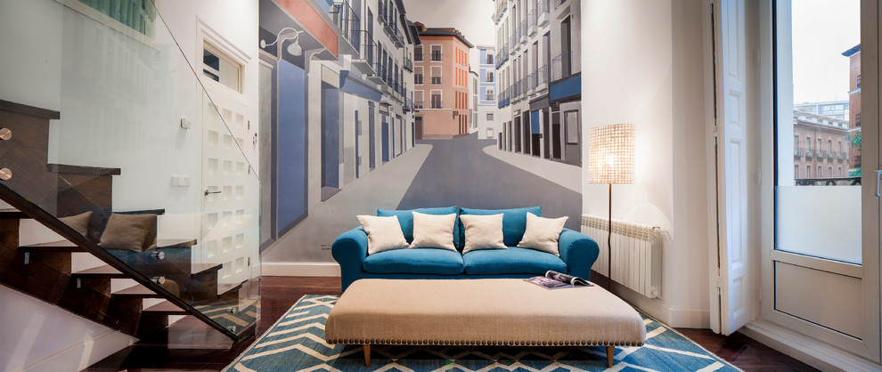 Mid-sized trendy formal and enclosed medium tone wood floor living room photo in Madrid with white walls and no fireplace