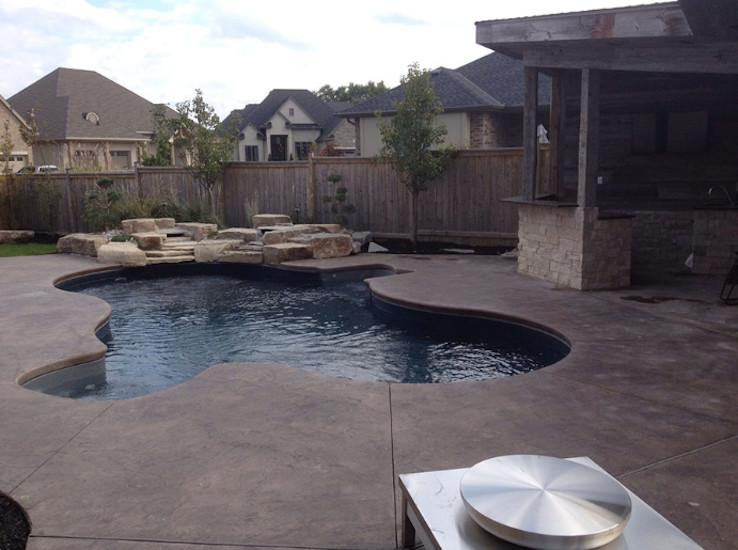 Small transitional backyard stamped concrete and custom-shaped natural pool fountain photo in Toronto