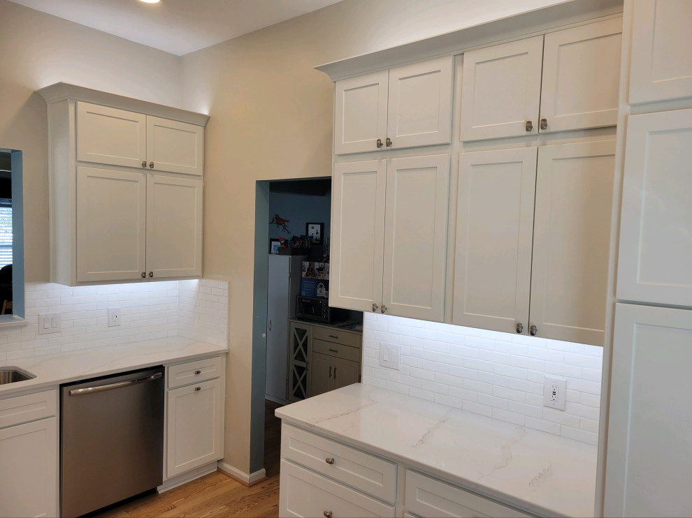 Mid-sized transitional enclosed kitchen photo with shaker cabinets, white cabinets, quartz countertops, white backsplash, subway tile backsplash and white countertops