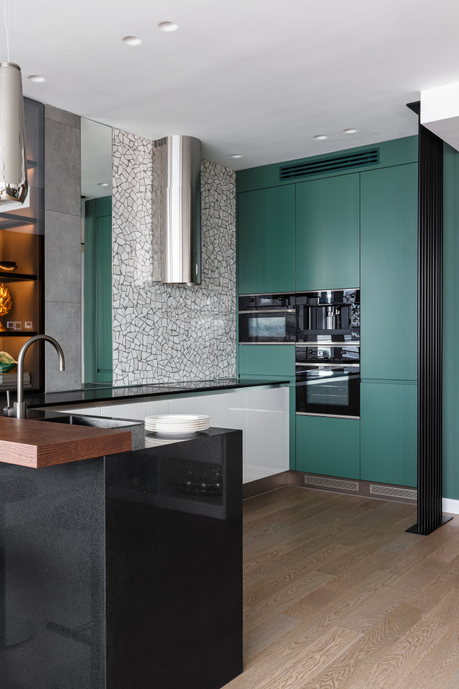 Inspiration for a contemporary open plan kitchen in Other with flat-panel cabinets and black worktops.