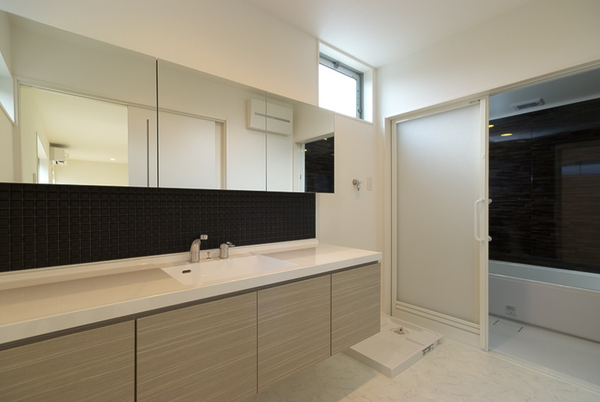 Mid-sized modern powder room in Other with white benchtops, flat-panel cabinets, grey cabinets, black tile, mosaic tile, white walls, vinyl floors, an integrated sink, solid surface benchtops, white floor, a floating vanity, wallpaper and wallpaper.