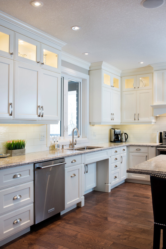 Kitchen - large transitional l-shaped medium tone wood floor kitchen idea in Toronto with an undermount sink, recessed-panel cabinets, white cabinets, quartz countertops, white backsplash, subway tile backsplash, stainless steel appliances and an island