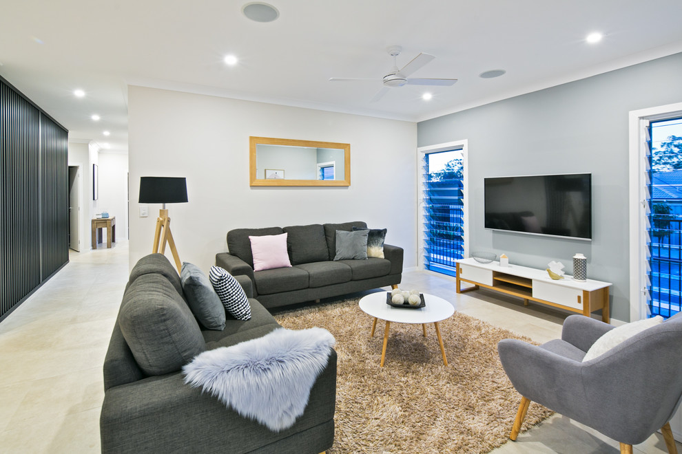This is an example of a mid-sized scandinavian open concept living room in Brisbane with grey walls, porcelain floors, a wall-mounted tv and grey floor.
