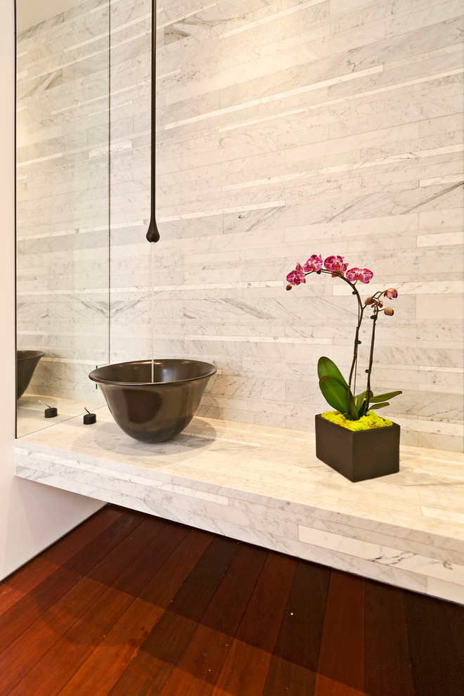 Design ideas for a contemporary powder room in Los Angeles with a vessel sink, white tile, dark hardwood floors and white benchtops.