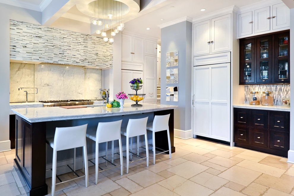 Photo of a contemporary l-shaped kitchen in Chicago with shaker cabinets, white cabinets, multi-coloured splashback and panelled appliances.