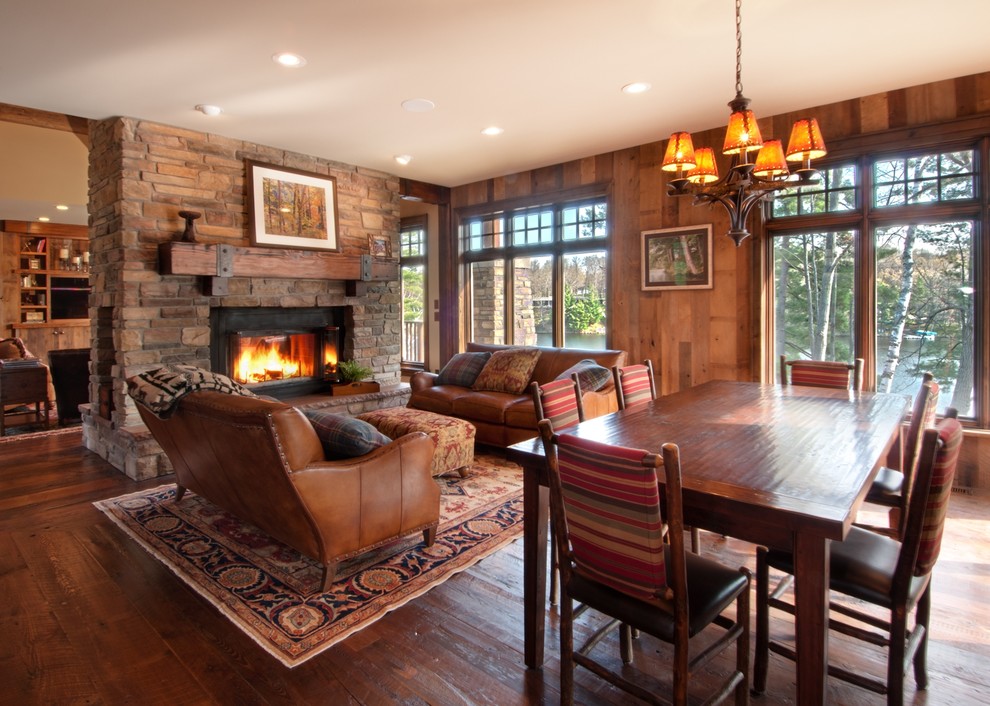 Inspiration for a country living room in Minneapolis with a two-sided fireplace, a stone fireplace surround and no tv.