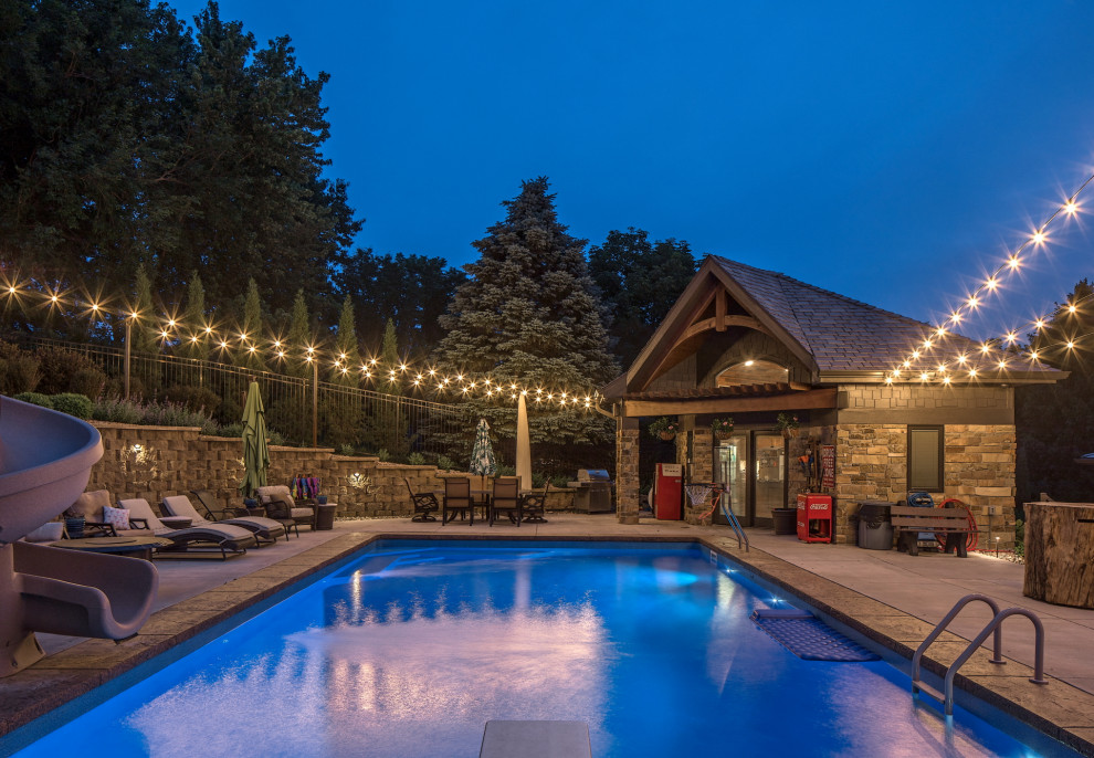 Design ideas for a country backyard rectangular lap pool in Omaha with a pool house.