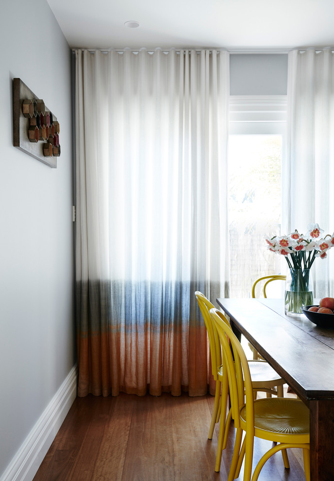Inspiration for a contemporary kitchen/dining combo in Sydney with grey walls, medium hardwood floors and no fireplace.