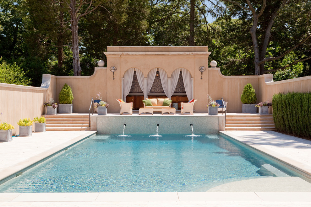 Pool fountain - mediterranean rectangular pool fountain idea in New York