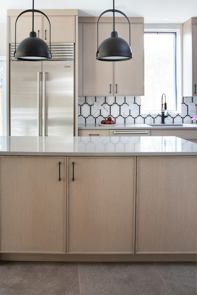 Transitional kitchen photo with an island