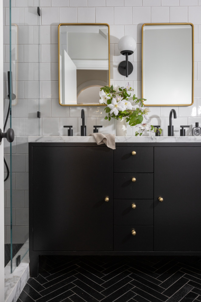 Small transitional master bathroom in San Francisco with recessed-panel cabinets, black cabinets, a one-piece toilet, white tile, ceramic tile, white walls, limestone floors, an undermount sink, marble benchtops, black floor, a hinged shower door, white benchtops, a shower seat, a double vanity and a freestanding vanity.