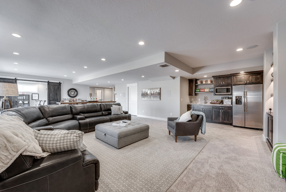 Large arts and crafts basement in Salt Lake City with grey walls and carpet.