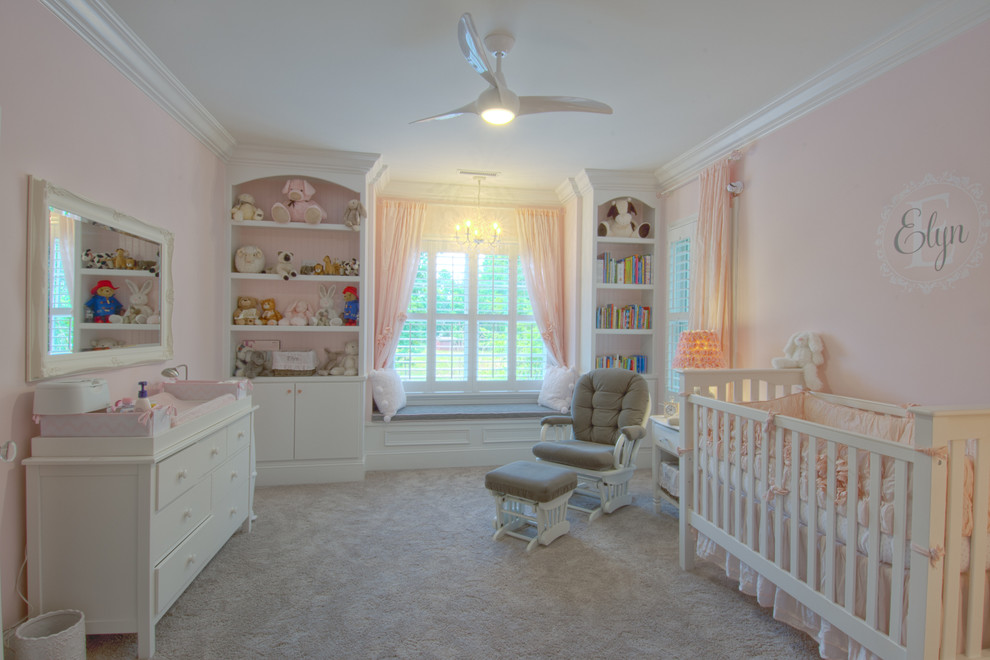 Inspiration for a traditional nursery for girls in Raleigh with pink walls and carpet.