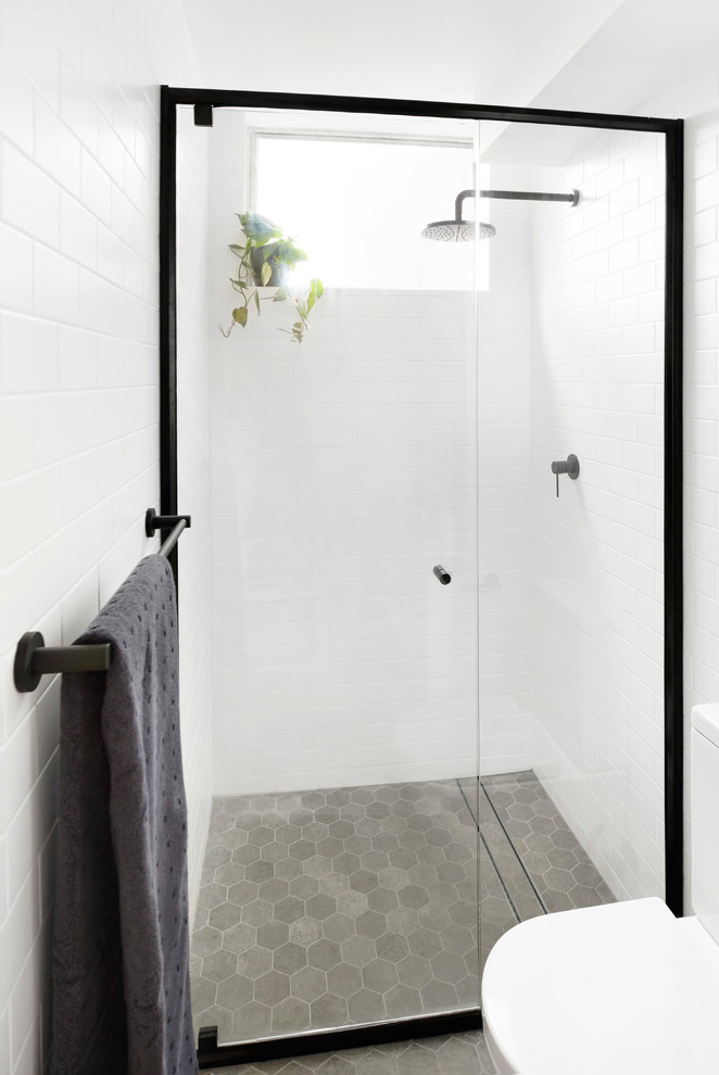 Small scandinavian bathroom in Other with louvered cabinets, white cabinets, a curbless shower, white tile, subway tile, ceramic floors, laminate benchtops, grey floor and a hinged shower door.