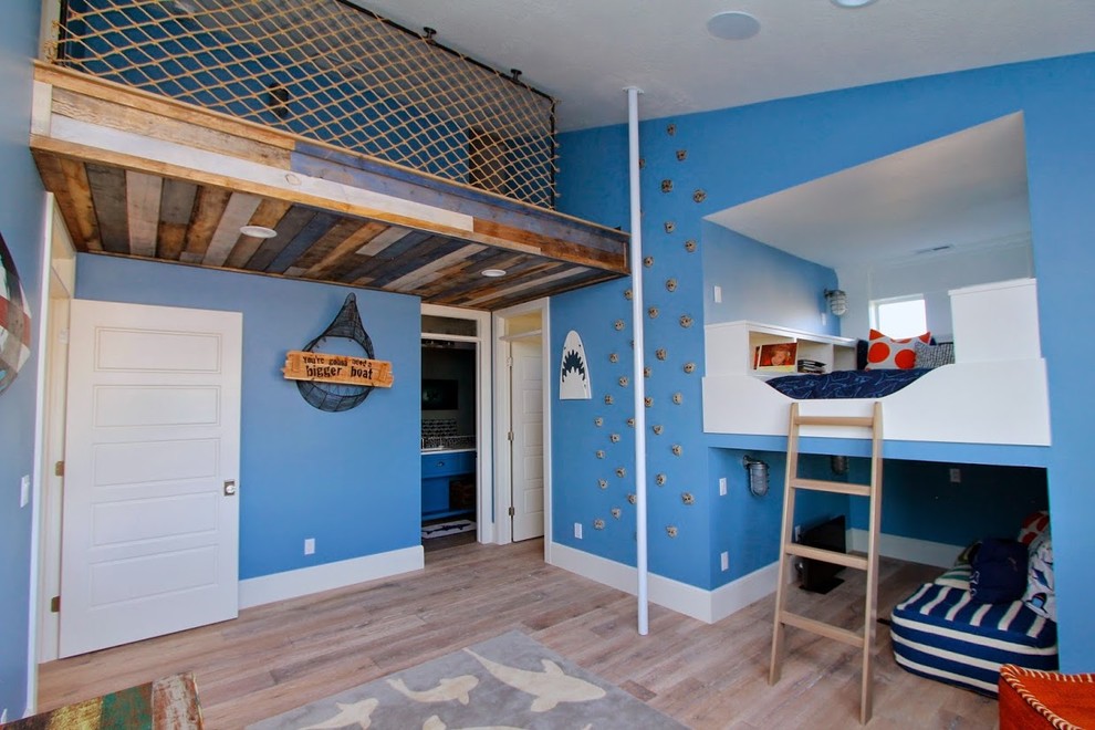 Large beach style kids' bedroom in Salt Lake City with blue walls and light hardwood floors for kids 4-10 years old and boys.