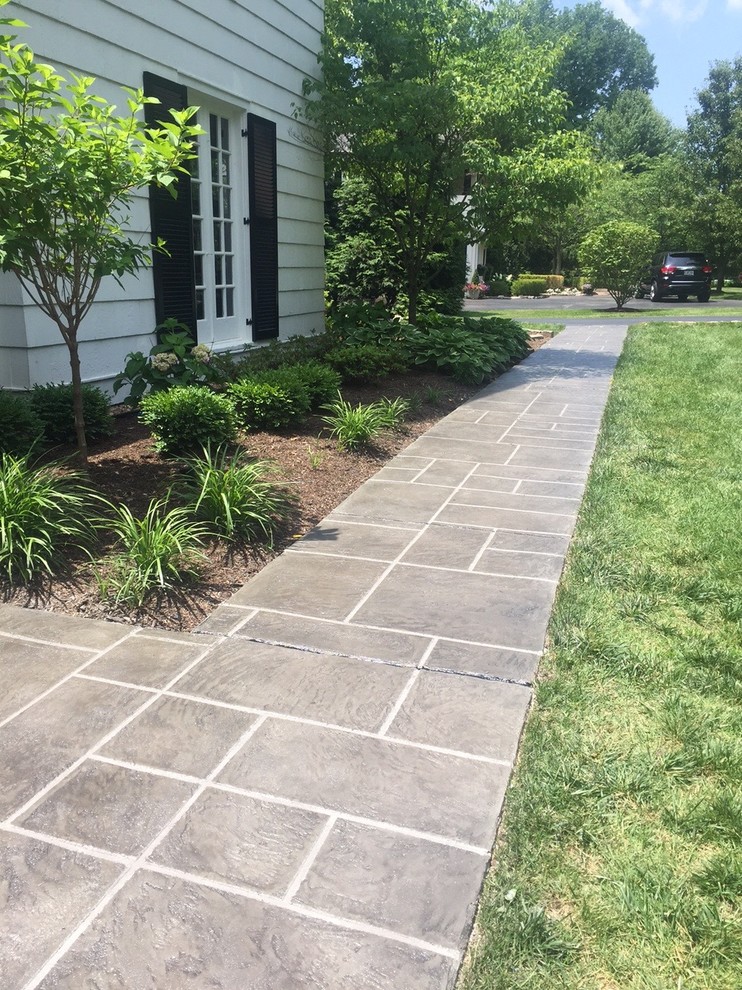 Mid-sized tuscan stamped concrete front porch idea in St Louis