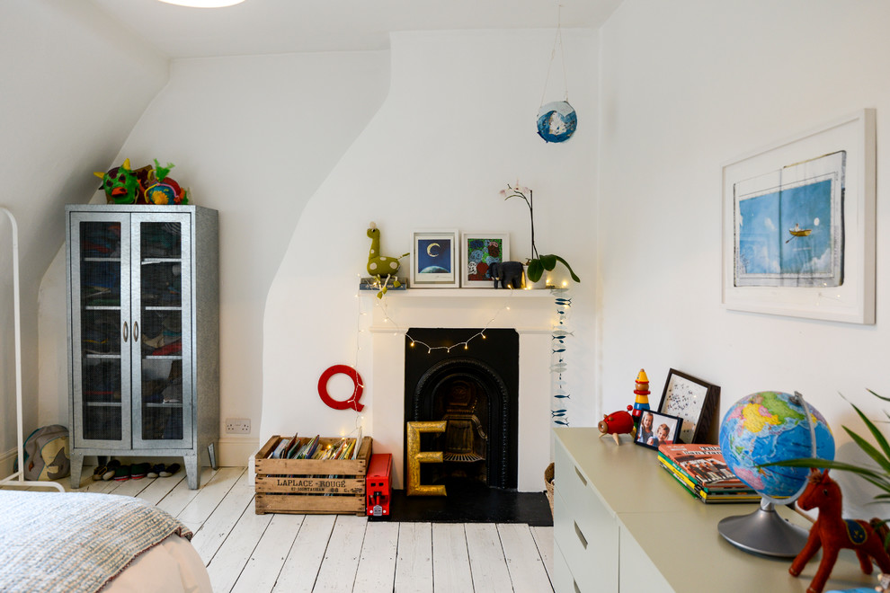 Photo of an eclectic kids' bedroom in London with painted wood floors and white floor.