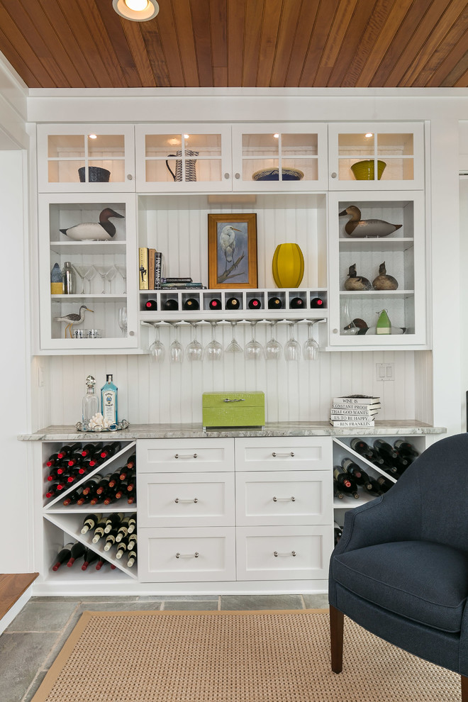 Photo of a mid-sized beach style single-wall home bar in Baltimore with no sink, shaker cabinets, white cabinets, white splashback and granite benchtops.