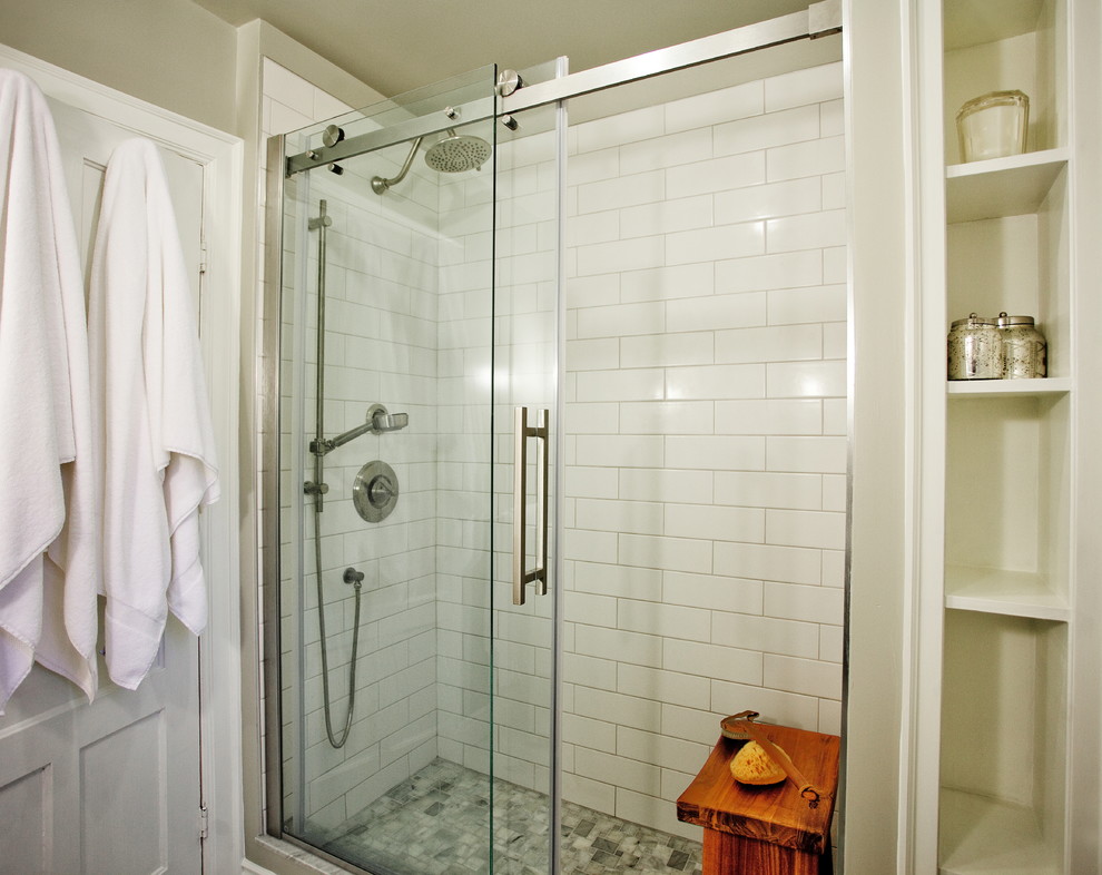 Photo of a small traditional 3/4 bathroom in Other with an alcove shower, subway tile, grey walls, furniture-like cabinets, grey cabinets, a one-piece toilet, an undermount sink, a sliding shower screen, ceramic floors and grey floor.