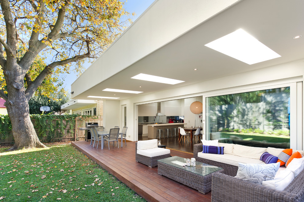Inspiration for a large contemporary backyard deck in Melbourne with a roof extension.