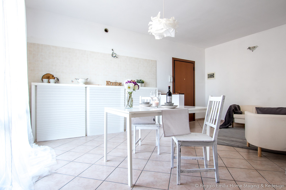 This is an example of a mid-sized contemporary single-wall open plan kitchen in Bologna with porcelain floors and beige floor.