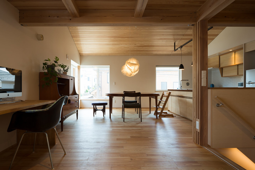 This is an example of a dining room in Tokyo Suburbs with white walls, light hardwood floors and beige floor.