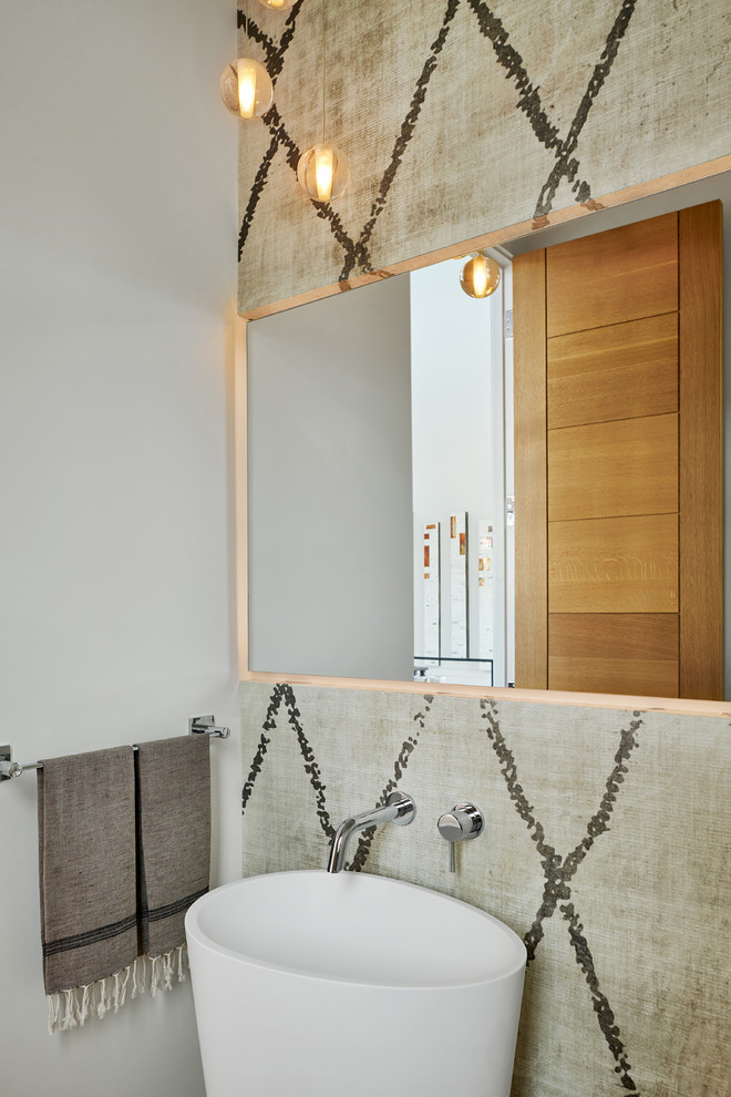Photo of a mid-sized contemporary powder room in Denver with a one-piece toilet, white walls and a vessel sink.