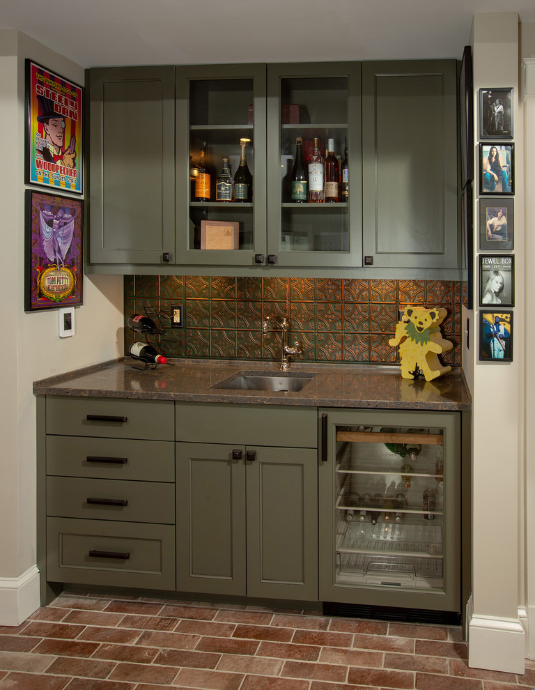 This is an example of a small traditional single-wall wet bar in DC Metro with porcelain floors, an undermount sink, glass-front cabinets, green cabinets, multi-coloured splashback and metal splashback.