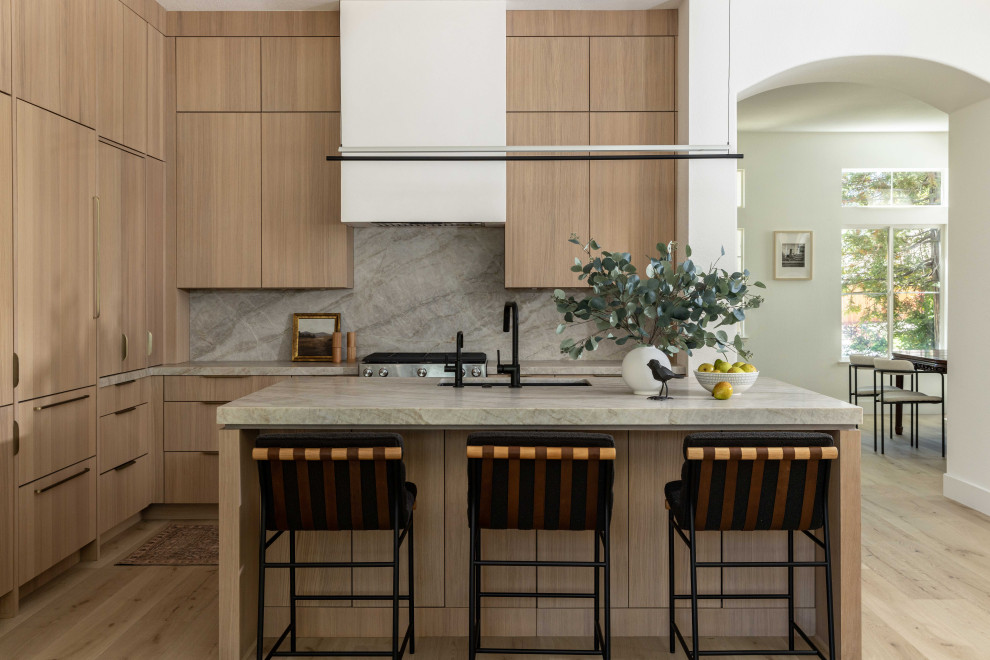Example of a danish l-shaped vinyl floor and beige floor open concept kitchen design in Sacramento with an undermount sink, flat-panel cabinets, light wood cabinets, quartzite countertops, multicolored backsplash, paneled appliances, an island, multicolored countertops and stone slab backsplash