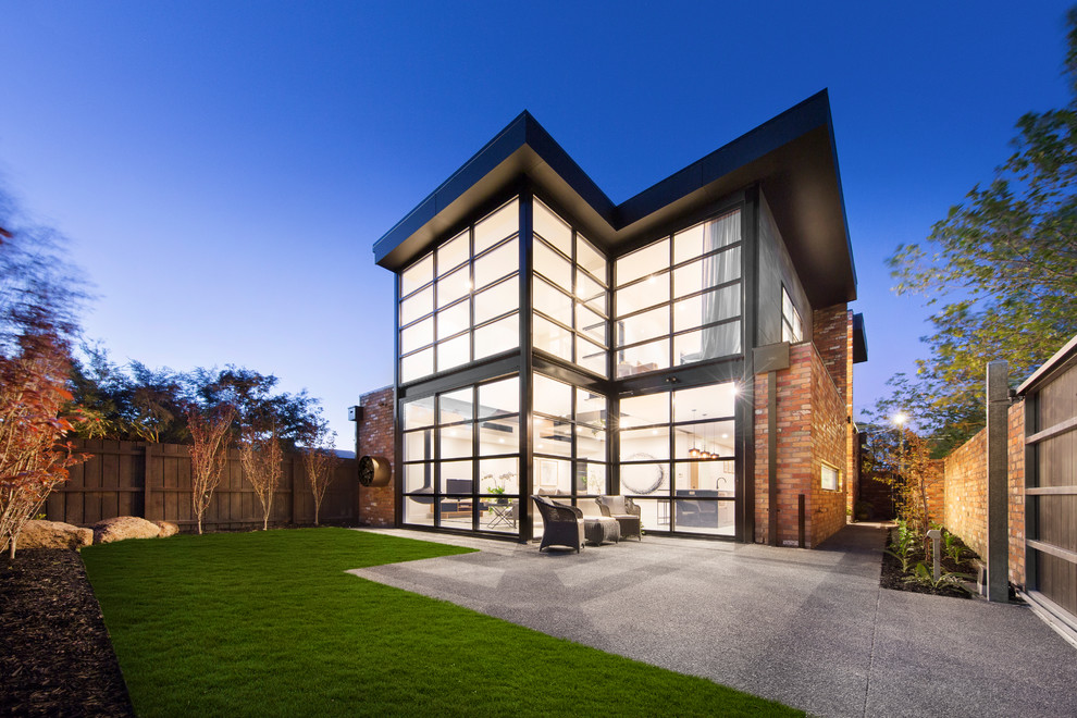 Photo of a contemporary two-storey glass exterior in Melbourne.