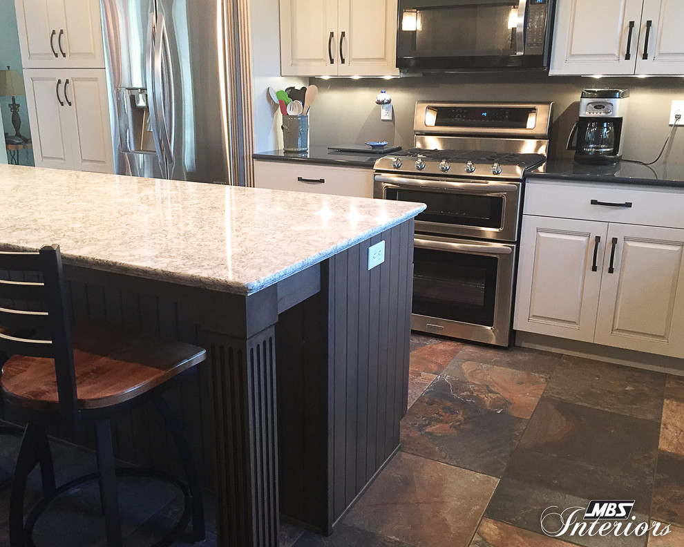 Example of a transitional l-shaped kitchen design with a farmhouse sink, white cabinets, quartz countertops, stainless steel appliances and an island