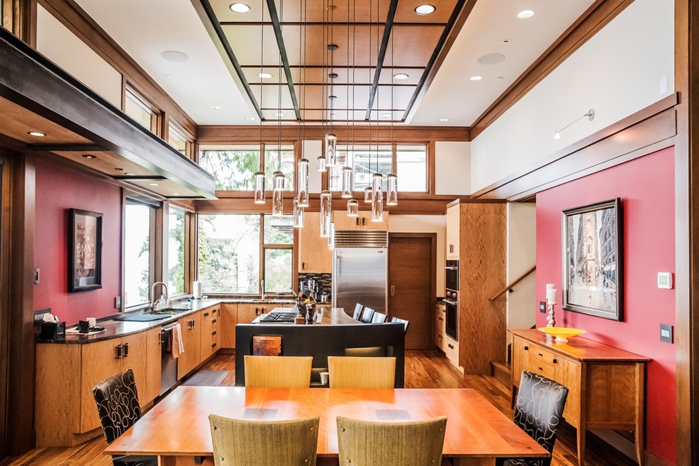 Photo of a mid-sized midcentury u-shaped eat-in kitchen in Seattle with a double-bowl sink, flat-panel cabinets, medium wood cabinets, wood benchtops, stainless steel appliances, medium hardwood floors, with island and brown floor.