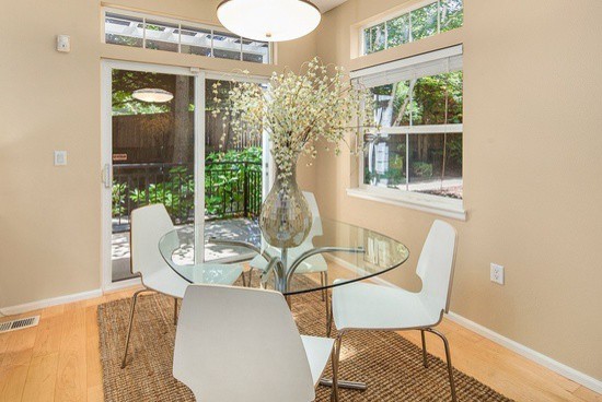 Inspiration for a small modern separate dining room in Seattle with beige walls, light hardwood floors and no fireplace.