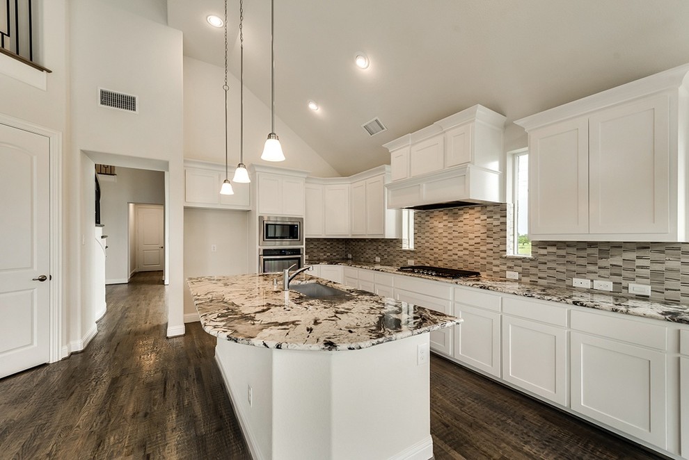 Inspiration for a mid-sized transitional l-shaped dark wood floor and brown floor kitchen remodel with an undermount sink, shaker cabinets, white cabinets, granite countertops, stainless steel appliances, an island and multicolored countertops