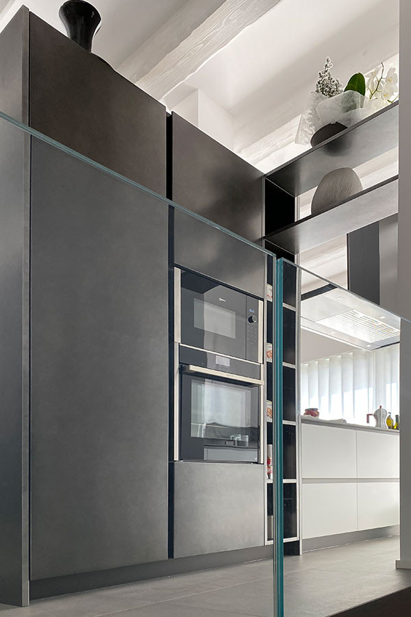 Inspiration for a contemporary galley eat-in kitchen in Other with an integrated sink, flat-panel cabinets, grey splashback, black appliances, porcelain floors, with island, grey floor, grey benchtop and exposed beam.