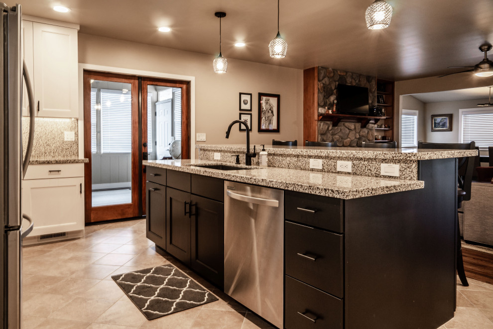 Example of a large transitional medium tone wood floor and red floor open concept kitchen design in Phoenix with an undermount sink, shaker cabinets, white cabinets, granite countertops, multicolored backsplash, granite backsplash, stainless steel appliances, an island and multicolored countertops